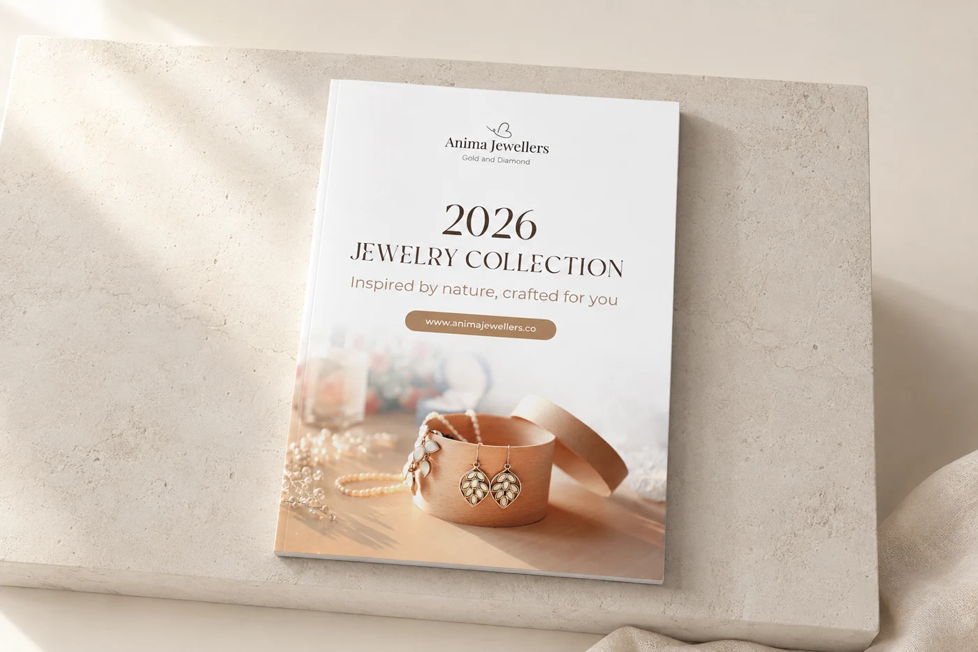 Anima Jewellers catalogue cover presented as a printed magazine on a pale stone plinth.
